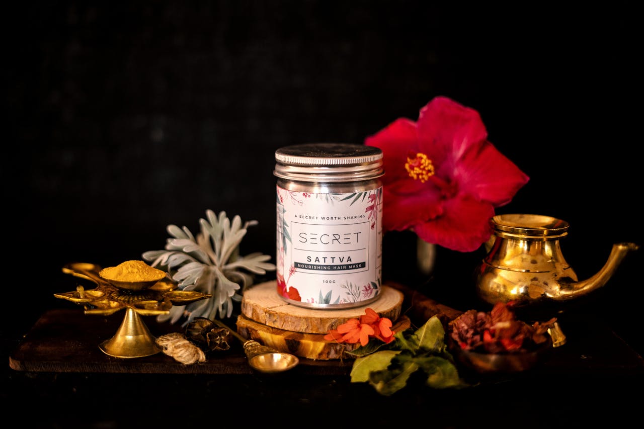 Elegant display of a nourishing hair mask with traditional Indian decor and vibrant flowers.