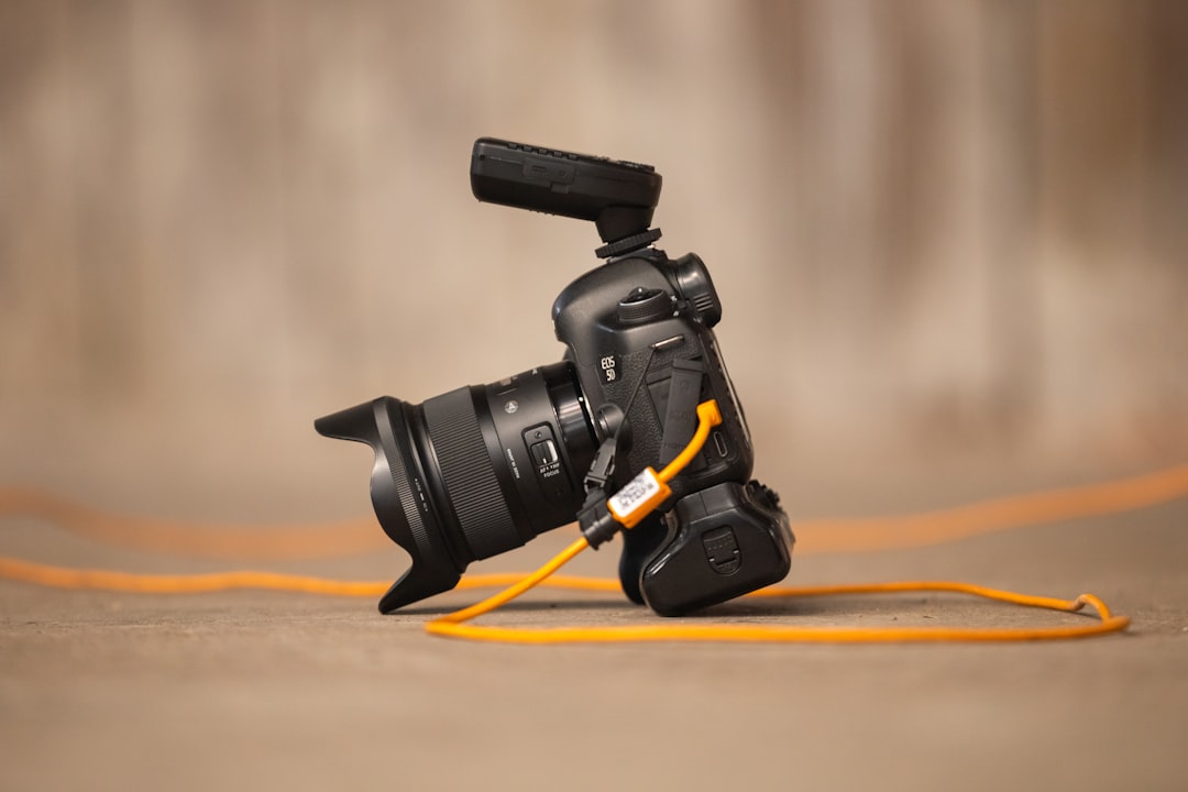 services-04 a-camera-with-a-yellow-cord-attached-to-it-erbcpr6stbk